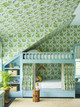 Children’s bedroom from the La Jungle collection, featuring mostly green panelled walls with a touch of blue. Jungle-themed wallpaper decorates the ceiling, matching the fabric curtains on the built-in bunk bed.